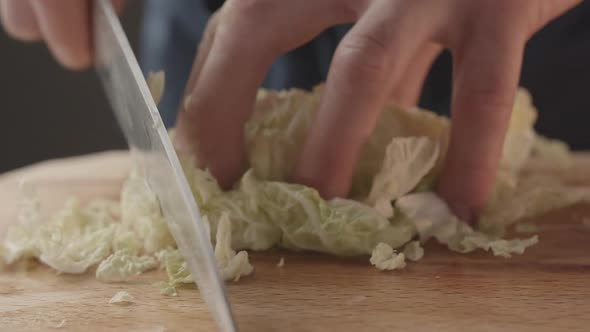 Man Cut with Knife and Hand Chinese Cabbage Preparation of Salad Ingredients