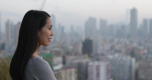 Young Woman looking over the city background