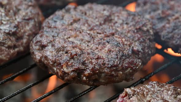 Cooking grilled beef meat barbecue burgers for hamburgers on bbq fire flame grill