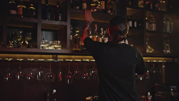 Bartender Makes Order on Phone for Missing Drinks in Bar