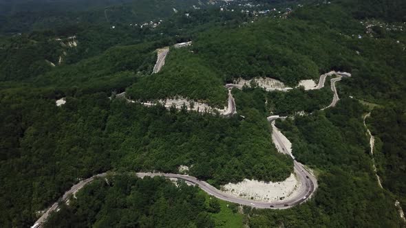 Aerial View From Above of Curve Road with a Car on the Mountain with Green Forest in Russia