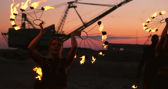 Fire Dancers Against Sunset