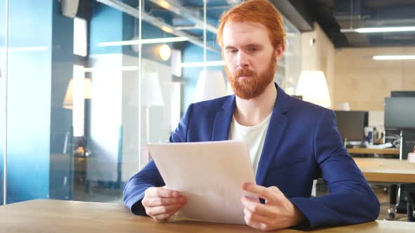 Man Reading Papers in Office