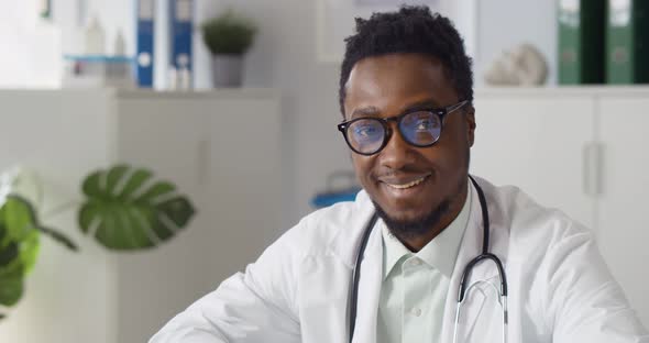 Happy Smiling African Doctor Looking at Camera in Office