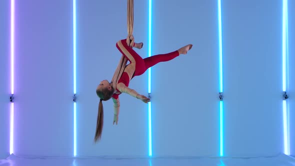 Aerial Gymnast Performing Aerial Acrobatic Dance on Silks in the Studio