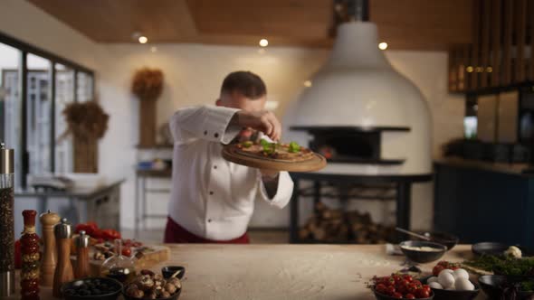 Professional Chef Presenting Pizza Cuisine in Italian Food Restaurant Kitchen