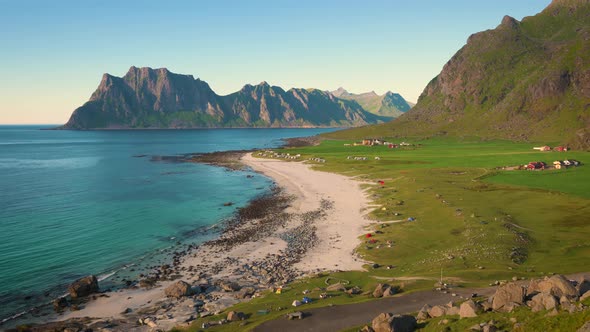 Pan Left of Uttakleiv Beach with Camping Tourists and Tents in Lofoten Norway