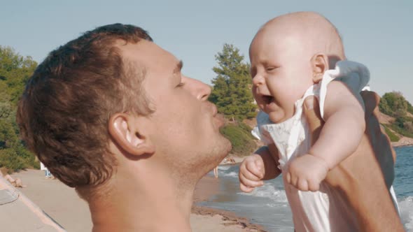 Happy Father Kissing Baby Daughter