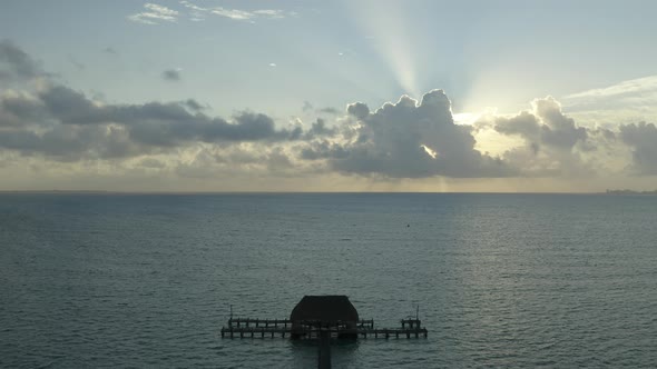 Tilt down view of Wooden stairs leading to swimming pier in the sea. Pedestal Down