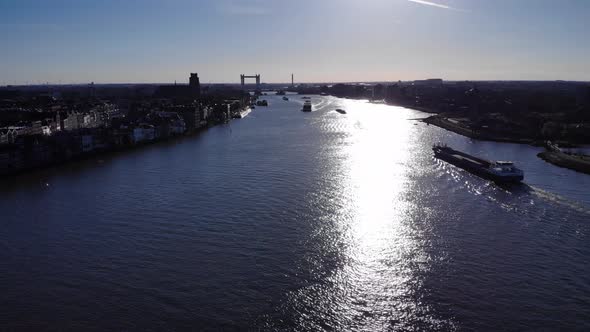 Narrowboat Crossing Oude Maas River In Puttershoek, South Holland, Netherlands With Distant View Of