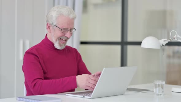 Successful Old Man Celebrating on Laptop at Work