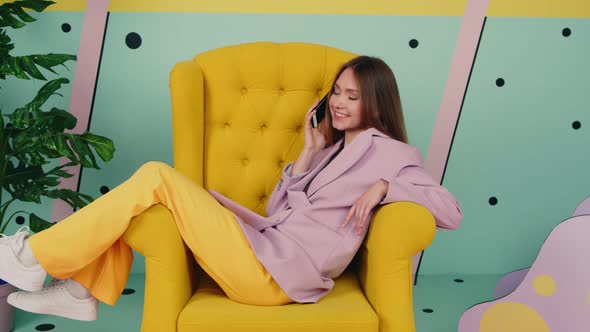 Woman In Trendy Suit Is Relaxing In Armchair