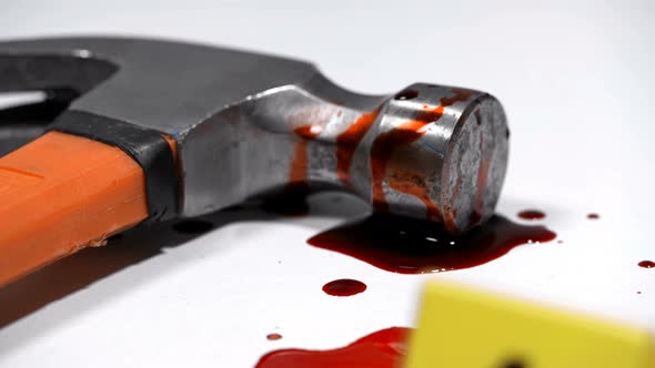 Blood Hammer on a Crime Scene Marked with a Photo Marker