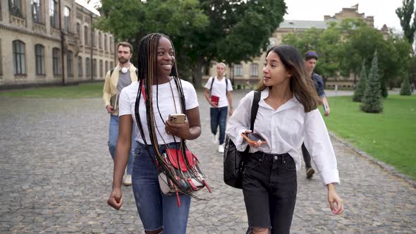 Multiethnic Girl Students Chatting Outdoors