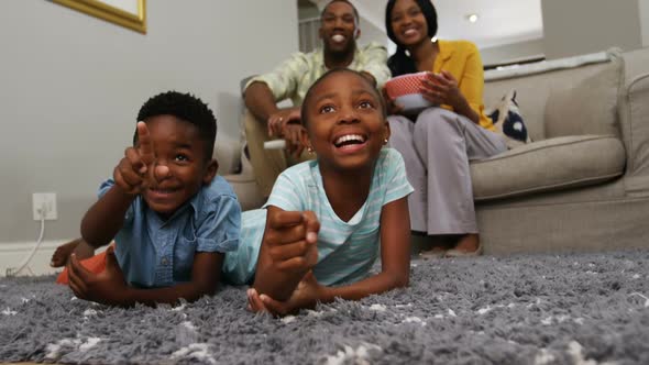 Family watching television in living room 4k