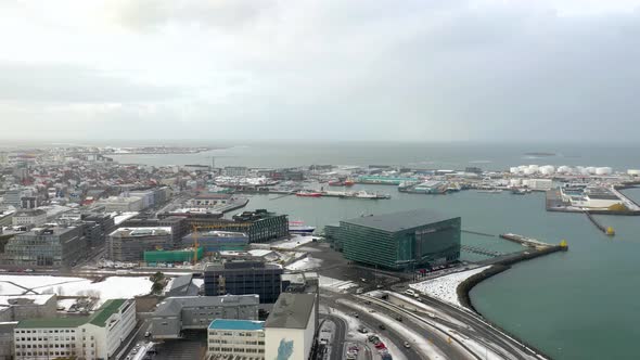 drone flies up to show the Harpan in the city of Reykjavik, Iceland