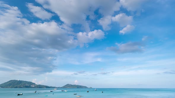 Beautiful blue sky white clouds over sea in the morning with Thai Longtail fisherman boats at Patong