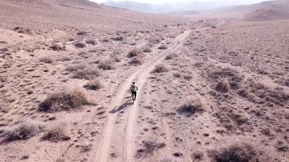 A Group of Cyclists Ride on the Steppe