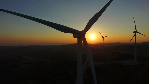 Close up of rotating windmill blades at sunset