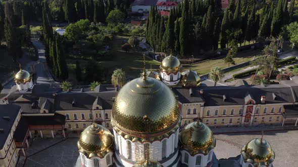 Aerial Shot Traditional White Religious Building Monastery with Golden Dome at City Forest Park