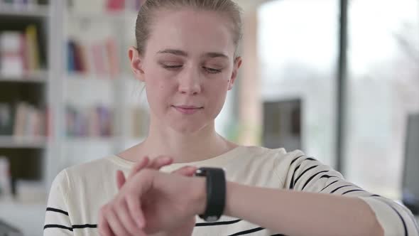 Portrait of Serious Young Girl Using Smart Watch