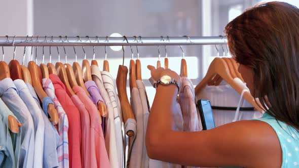 Pretty woman doing shopping at clothes store