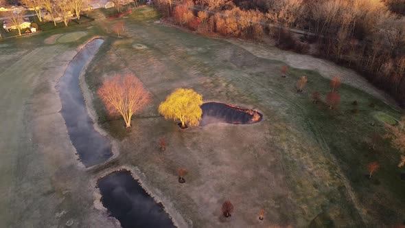 Top-Down Drone Shot Of Misty Golf Course Early In The Morning