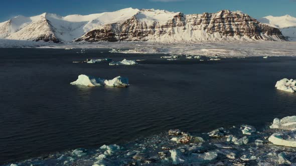 Aerial view of melting icebergs on lake at Jökulsárlón Glacier on Iceland during sunny day