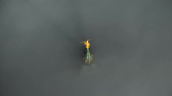 Epic Aerial Close-up Shot of Heavenly Golden Statue on Mont Saint Michel Castle Steeple Top Above