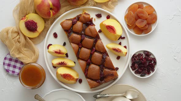 Delicious Homemade Peach or Nectarine Cake, Fresh Fruits, Marmalade, Cranberry on Stone Background