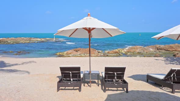 Tropical Holiday Concept, Sunbeds and Parasols on Beach With Horizon View