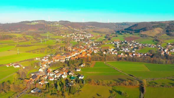 flight over small village in the countryside on a sunny afternoon