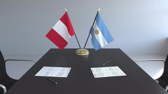 Flags of Peru and Argentina and Papers on the Table