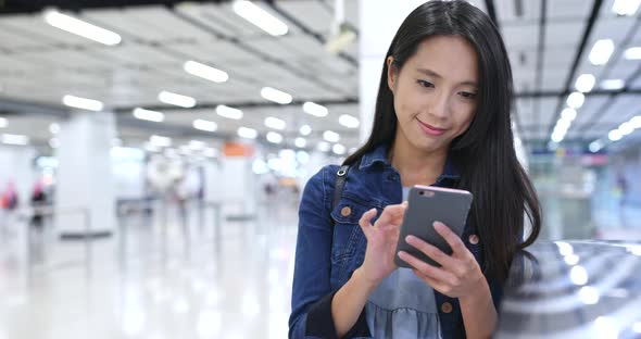 Woman use of mobile phone in station 