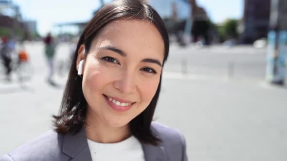 Young Smiling Asian Business Woman Standing on City Street Close Up Portrait