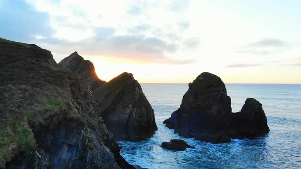 Rock formation in sea at dusk