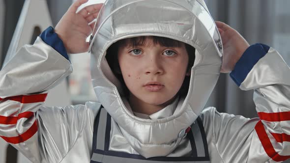 Portrait of Boy in Spacesuit Looking at Camera