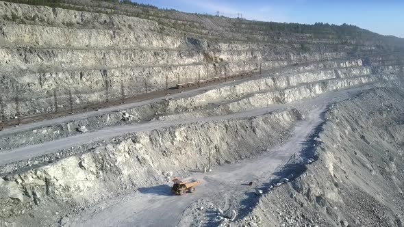 Aerial View Empty Dump Truck Drives Up To Excavator