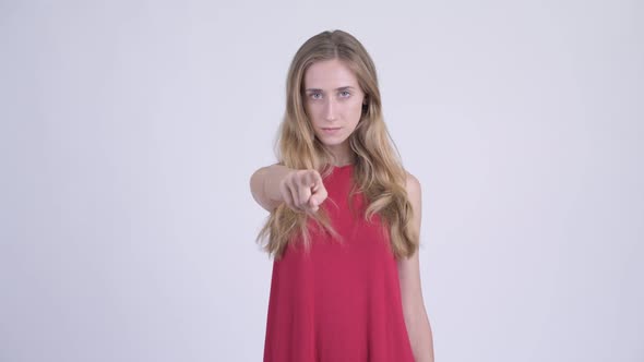 Young Serious Blonde Woman Pointing at Camera