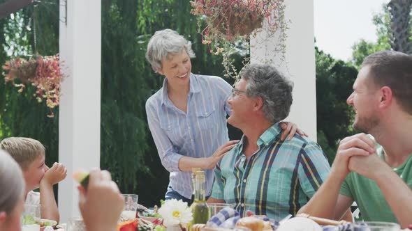 Happy family eating together at table