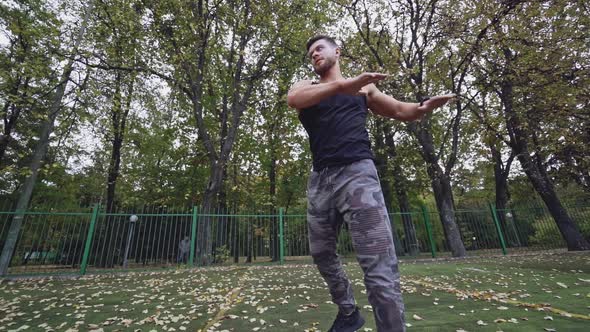 Young man exercise outdoors. Athletic man training at the stadium