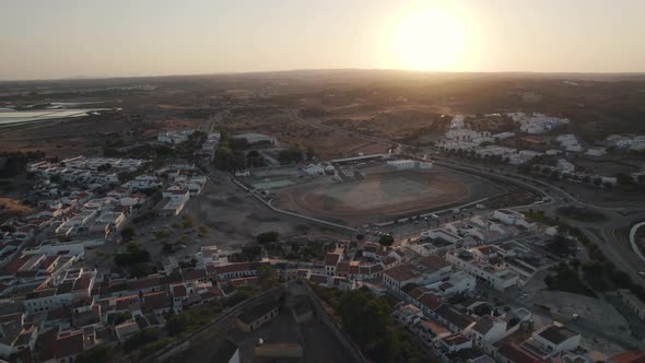 Aerial pull out shot capturing the fortification and Castelo de Castro Marim castle at sunset.