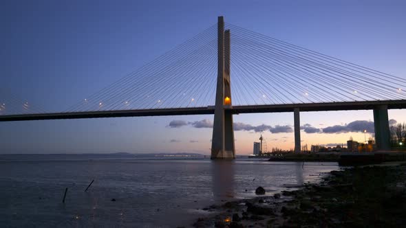 Ponte Vasco da Gama Bridge view near the Rio Tejo river at sunset