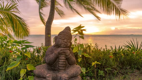 Little Buddha statue beside the sea at the sunset time in Koh Samui, Thailand