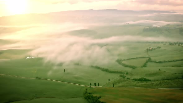 Flying over the foggy Tuscany Italy landscape