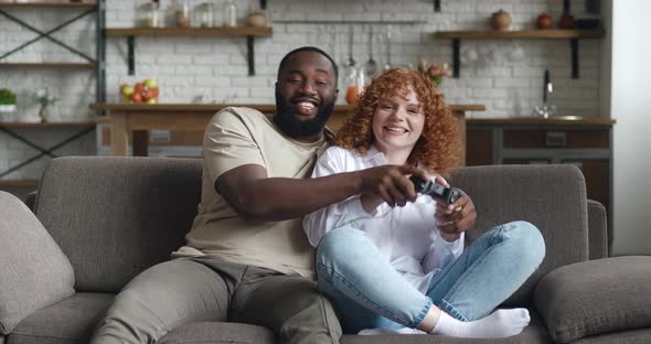 African American Guy and Asian Womancomputer Game Addicted Clicking on Joystick While Actively