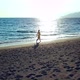 Aerial Drone Footage of a Girl Walking Along a Lonely Beach - VideoHive Item for Sale