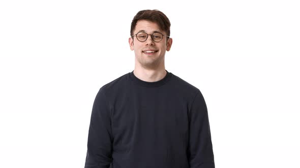 Portrait of Pleased Man Wearing Black Sweatshirt and Glasses Nodding and Expressing Acceptance with