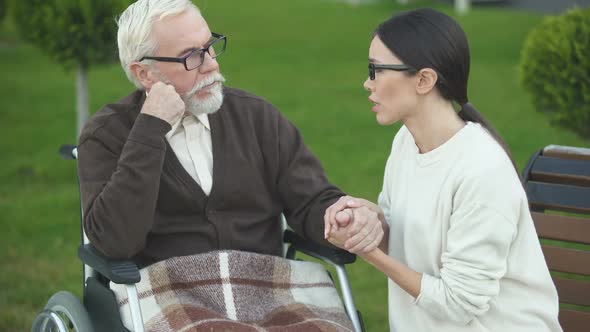 Upset Granddaughter Sitting Near Depressed Old Male, Bad Diagnosis, Dementia