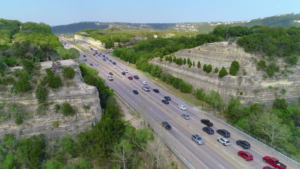 Bumper to bumper car traffic near Austin, Texas. Vehicles moving slowly on one side while moving qui